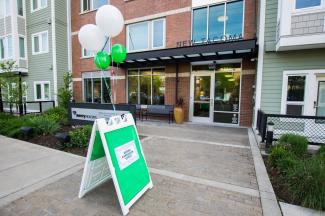 Apartment building with welcoming sign and balloons